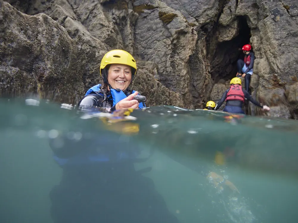 Women surfing during a retreat in Pembrokeshire Wales