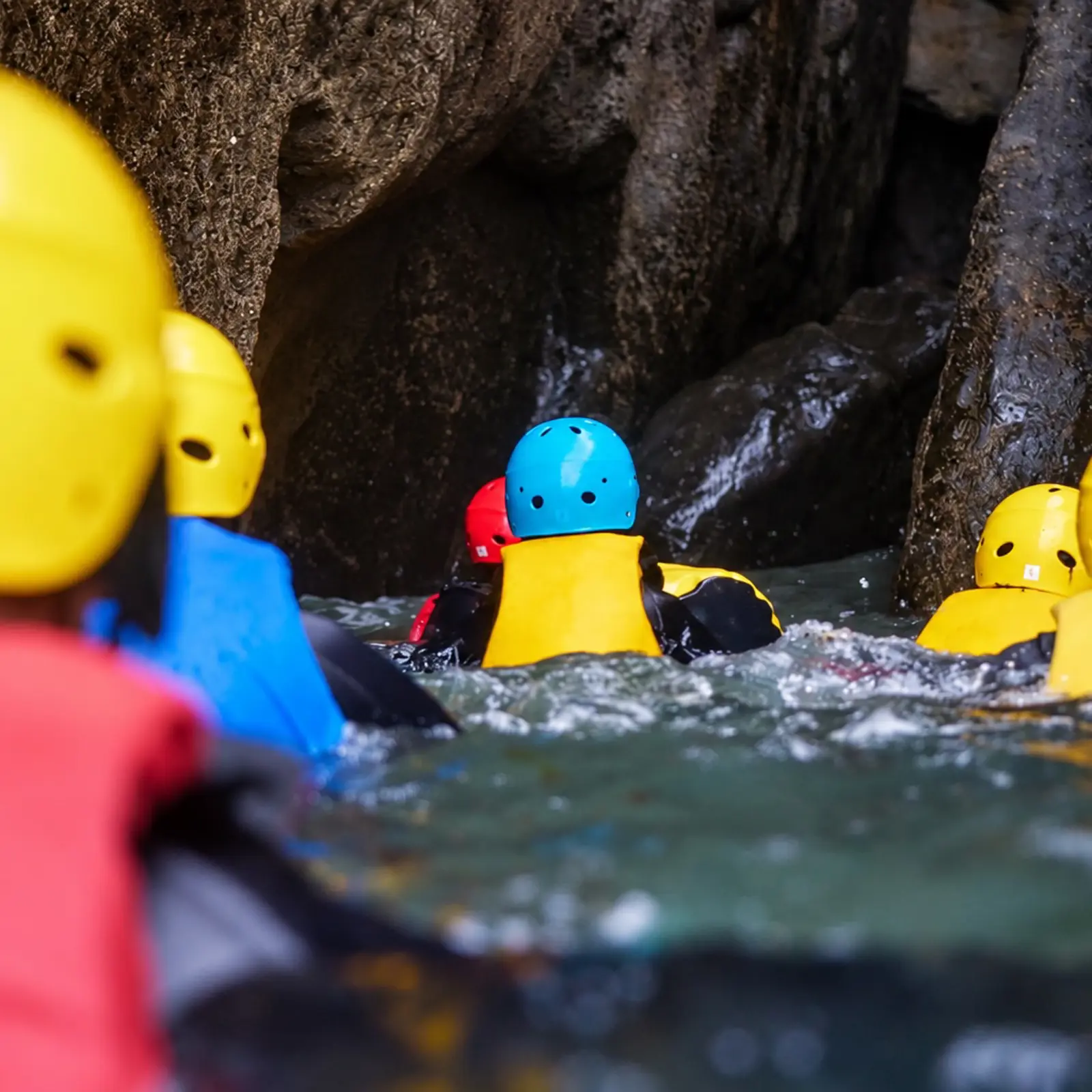 Exploring a dramatic rocky coastal gorge during a coasteering session