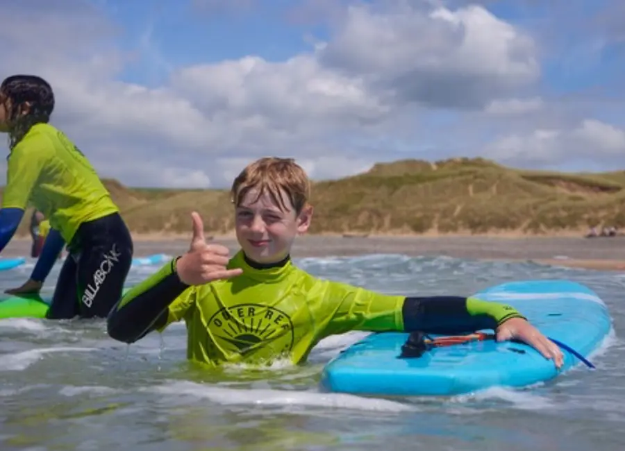 Child enjoying Outer Reef surf camp in Pembrokeshire
