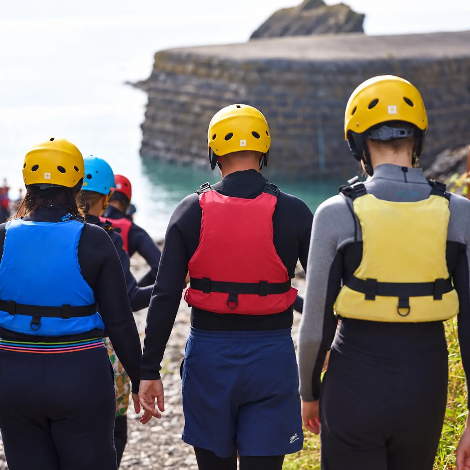 Coastal adventure group wearing buoyancy aids in Pembrokeshire