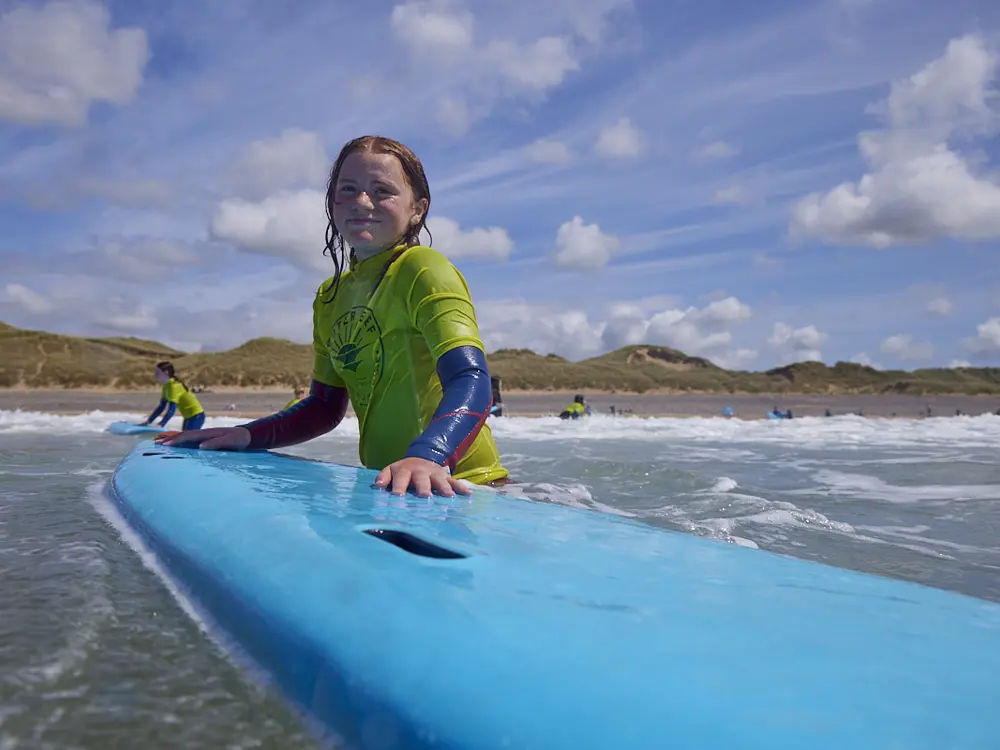 Young Surfer Paddling During Surf Camp In Wales